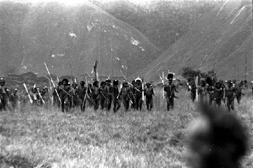 Group of warriors running back from the battle front