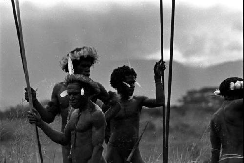 Decorated warriors waiting with their long spears in hand