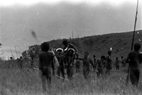 Wounded warrior being carried from the battle front on the shoulders of another warrior