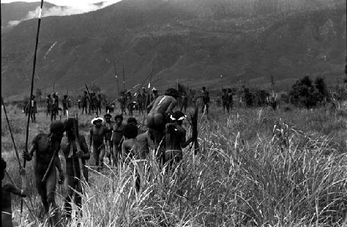 Warriors heading away from the camera; towards the battle front