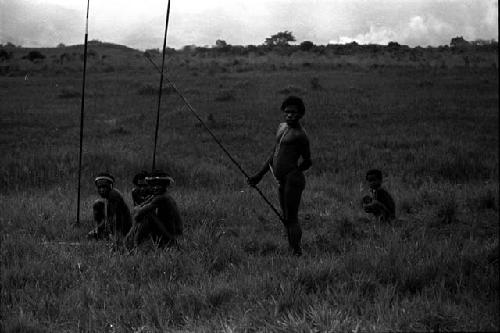 Men waiting with their spears on the Tokolik, a young boy with them