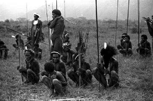 Seated warriors watching the battle from a rear position