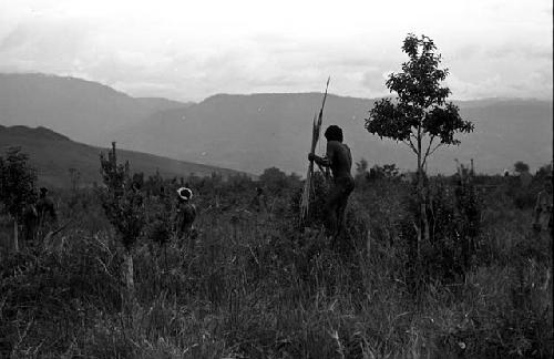 Warriors with spears closer to the front lines, calling out at the enemy