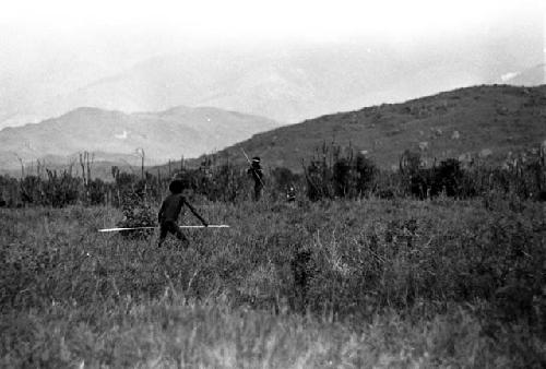 A man from the Willihiman-Wallalua (foreground) battling with an enemy from the Wittaia (background) -- Wittaia shoots at warrior in foreground