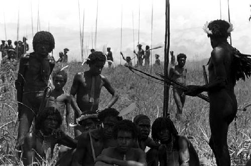 A group of men waiting near the Tokolik, others beyond