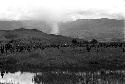 Long line of warriors going past the pond on the wat to a war on the Tokolik