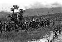 Large group of spearmen coming back from the front, some walking through the deep water of the pond