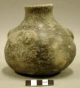 Ceramic vessel, burnished, short flared neck, 4 faces in relief at shoulder