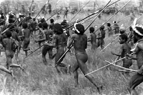 A large group of men running to the front, weapons in hand