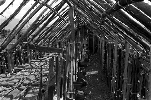 Looking down the aisle of a wamai (pig stye) under construction in the new village of Kumina