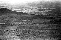 Men gathered on the Tokolik just as a battle is beginning; hills beyond