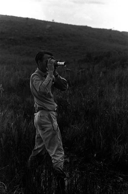 Robert Gardner filming warriors going home along the ridge of the Warabara