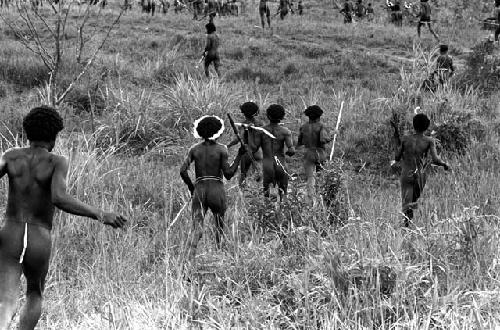 Men running down to join the action at a war on the Tokolik