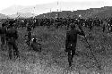 Very large group of warriors waiting on the Tokolik, many spears among them; hills beyond