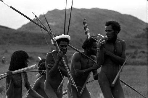 Men coming back from the battle front with their weapons