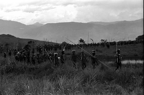 Men coming back from the battle front, along the pond on the Tokolik