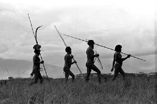 Men coming back from the battle front with their weapons