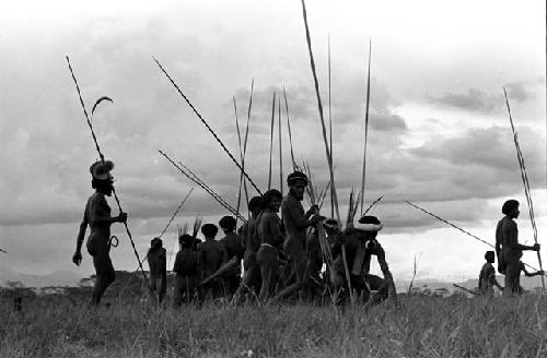 Men coming back from the battle front with their weapons