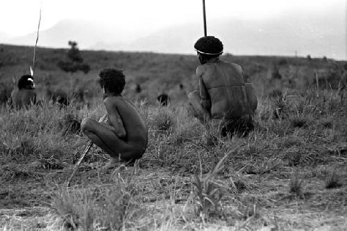 Men sitting with their weapons