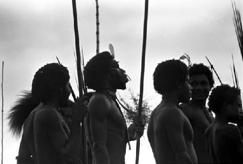 Men yelling towards the battle front, mocking the enemy