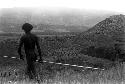 Men going down to the battle front, seen from a distance in the middle ground