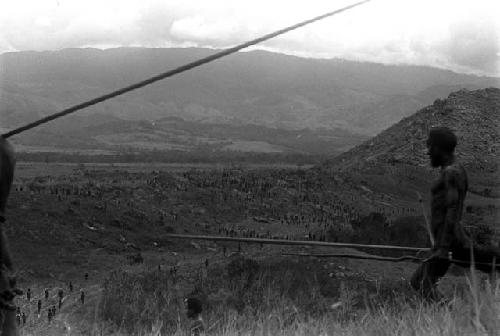 Men going down to the battle front, seen from a distance in the middle ground