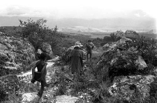 Young boys carrying expedition equipment on the path to Lokoparek