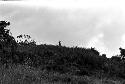 A figure stands on the hill behind Abukulmo