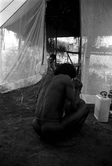 Weaklekek butchering meat in the expedition dining tent