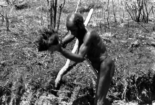 Alugu working on a ditch in his garden