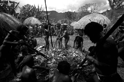 Men lifting stones from a fire, to be put into the haksé
