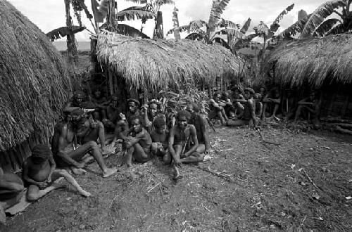 Men and children sitting in a sili