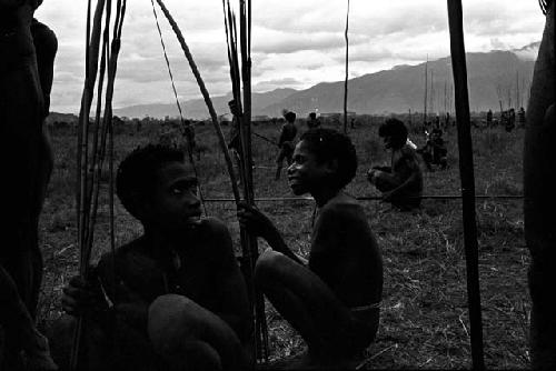 Men wait with their long spears at the rear of a battle