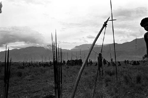 A large group of men waiting with spears at the rear of a battle