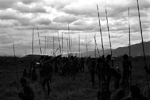 A group of warriors waits with long spears in hand