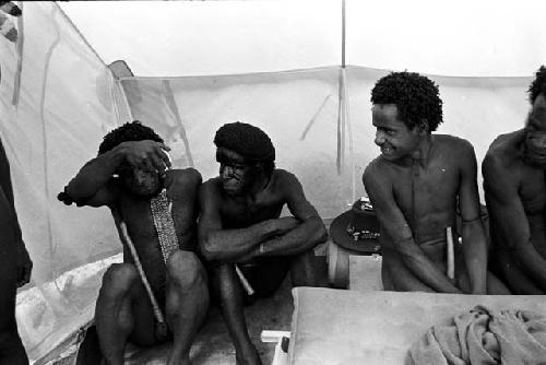 Tekman Biok and other men clowning  in Robert Gardner's expedition tent