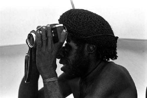 Tekman Biok looks through a Nikon camera