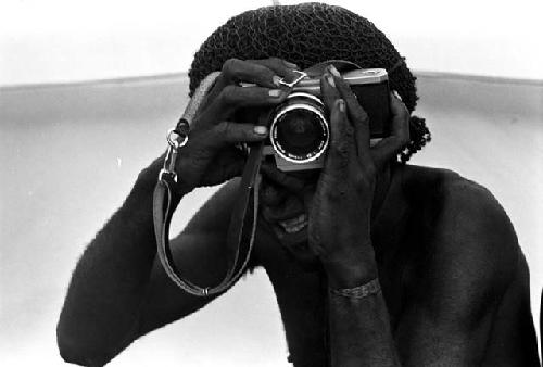 Tekman Biok looks through a Nikon camera