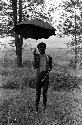 A man standing under an umbrella