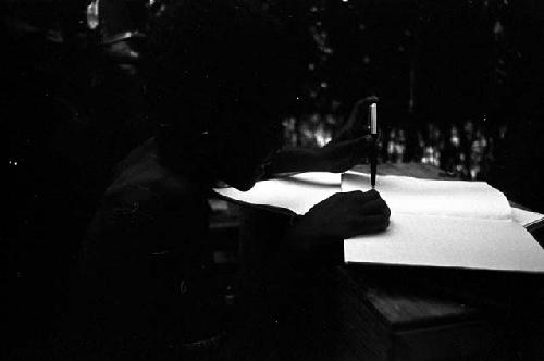 Men using an expedition member's pen