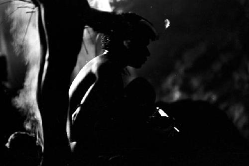 Men sitting near the mouth of a bat cave