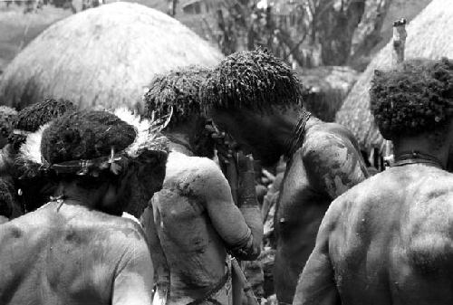 men around the pia mourning