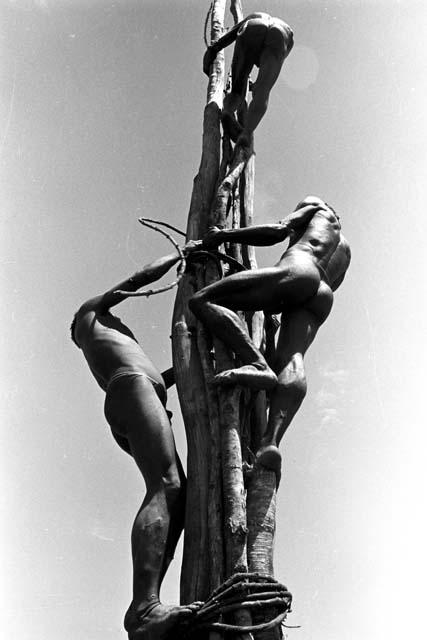 men on the pole working their way up