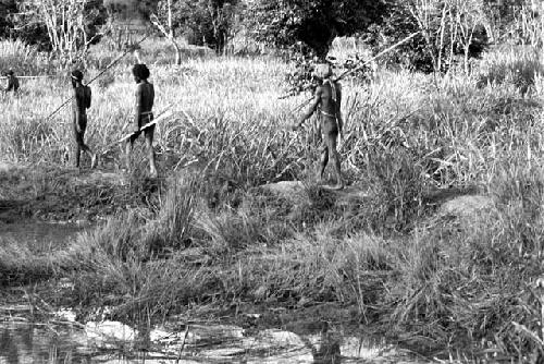 a group of men waiting by the Tokolik pond