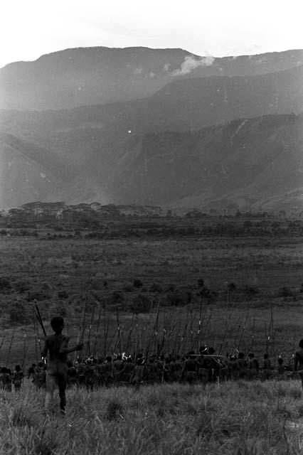 Men leaving a war on the Warabara; going through the marsh