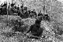 Men sitting on the Warabara, spears in hand