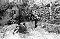 Boys sit by a place where wood is gathered, near Lokoparek