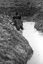 Men working on a garden ditch