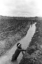 Men working on a garden ditch