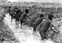 Men working on a garden ditch